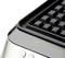 Close-up of a waffle iron with a grid pattern, two round buttons visible on the front.