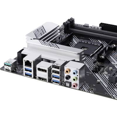 Computer motherboard with USB ports, HDMI and audio sockets. Rectangular black components on a silver circuit board.