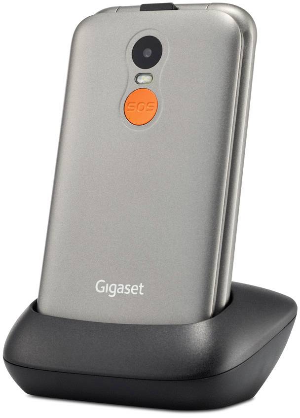 Mobile phone on charging station with visible 'SOS' button on the back.