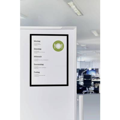 On a whiteboard, days of the week are listed with meals for each day. In the background, a modern office with empty workstations.