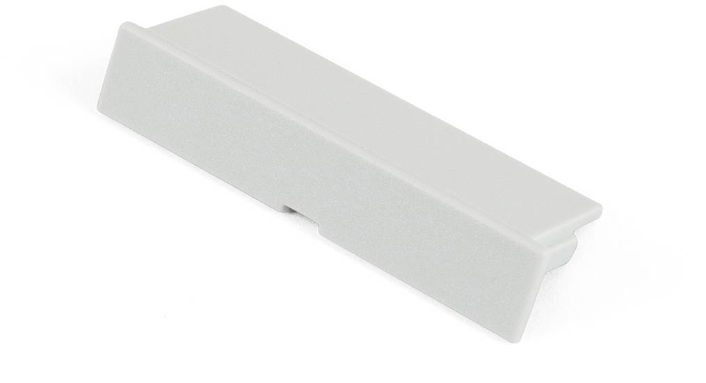 A grey, rectangular plastic component with a bevelled edge, possibly a part or cover, on a white background.