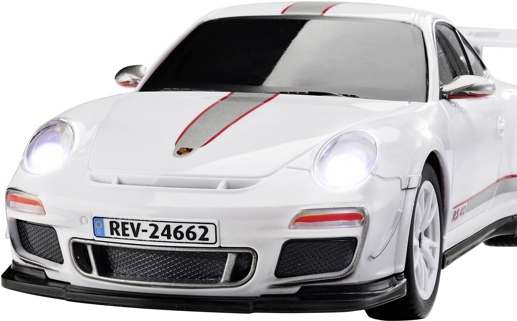 A white toy car with red racing stripes, based on a sports car model. The headlights are illuminated.