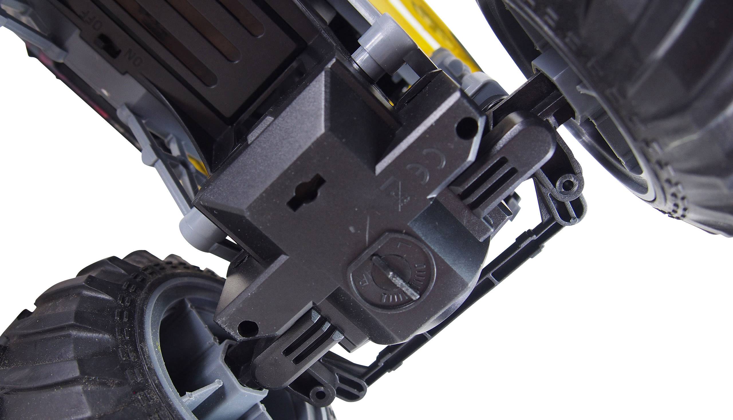 Close-up of a black plastic gear wheel with large wheels on the left and right sides. Gears and mechanism visible.