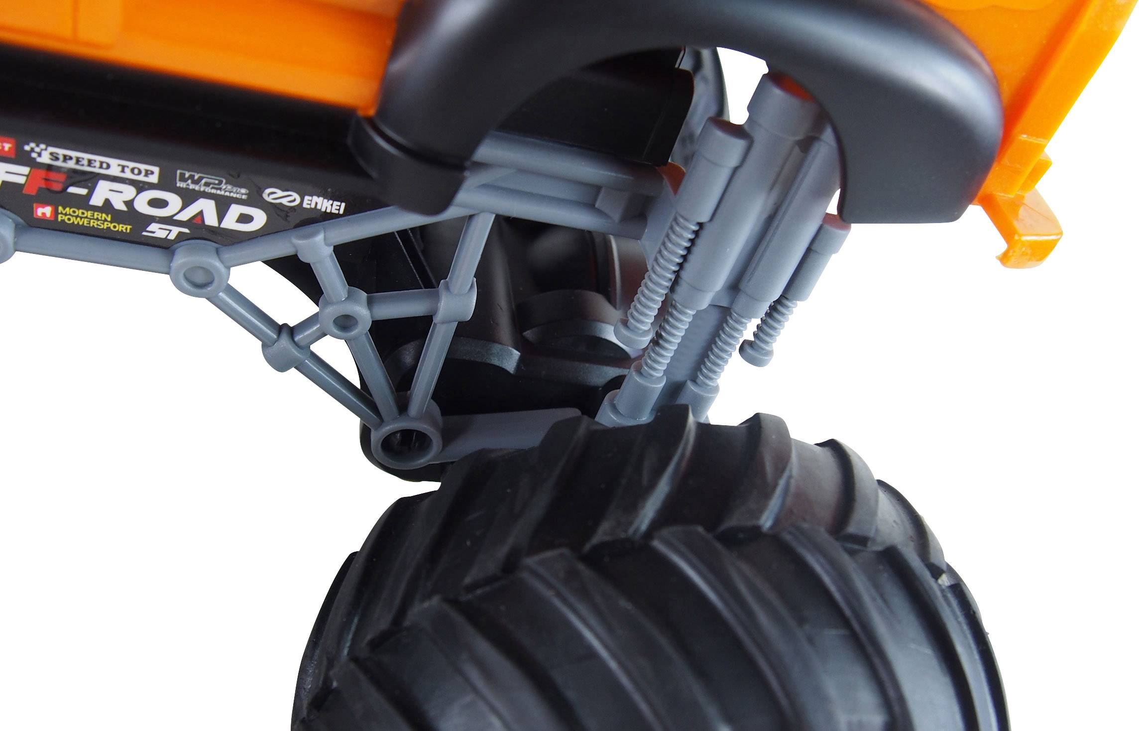Close-up of a toy off-road vehicle with large, robust tyres and a prominent orange bodywork section.