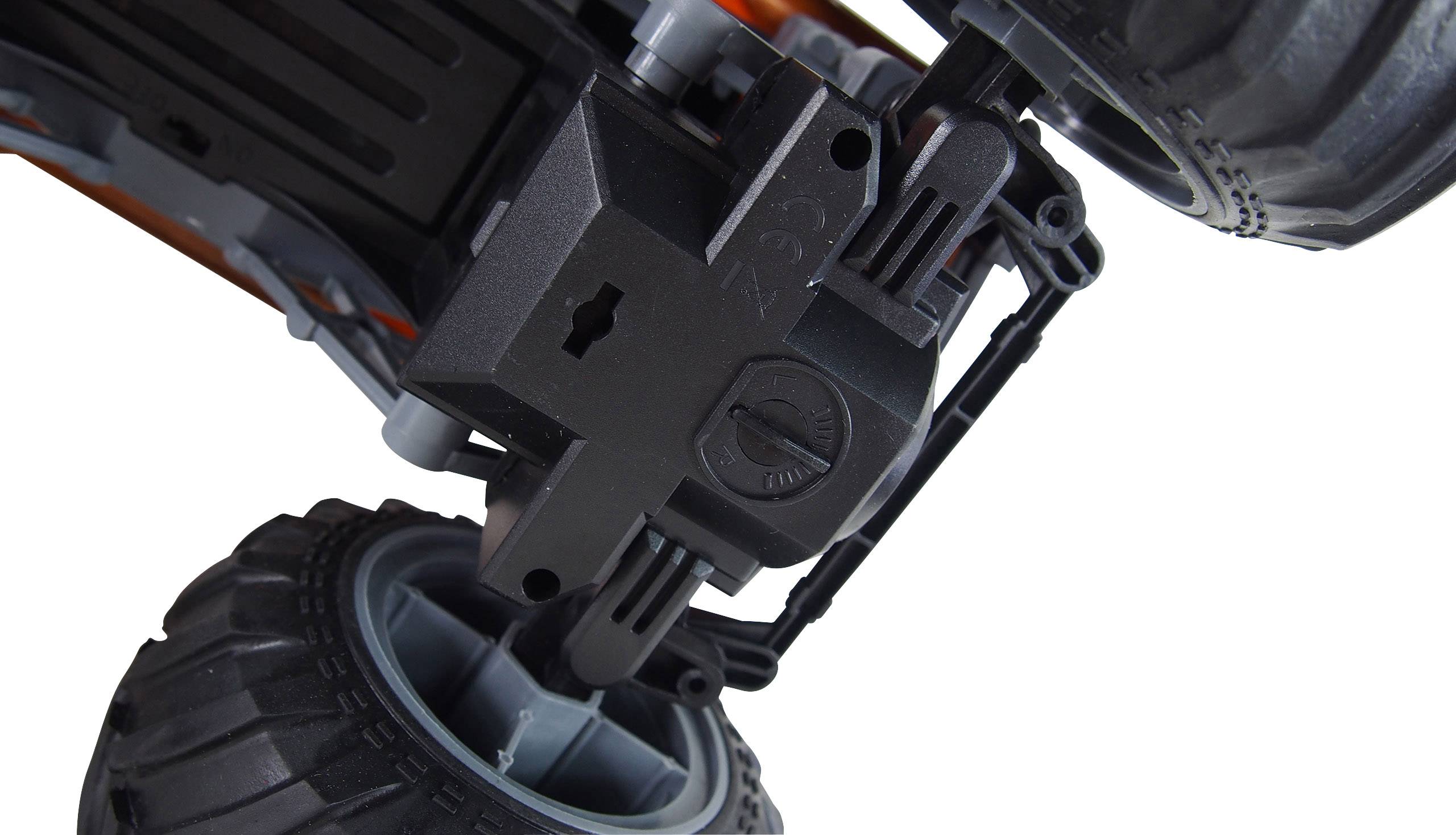 Close-up of a toy lorry wheel and its mounting, presented from an unusual angle to highlight technical details.