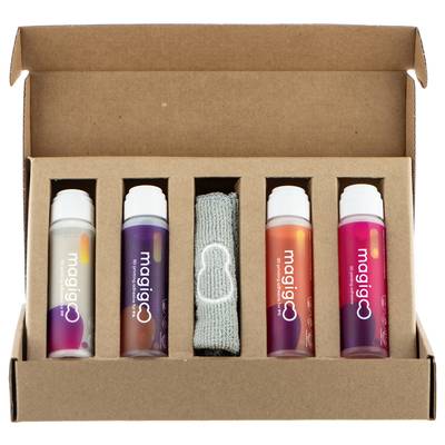 An open box containing four Magigoo adhesive bottles and a grey cloth inside, likely a cleaning accessory.