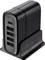 Black USB charger with four USB ports and a USB-C PD port, standing on a table.