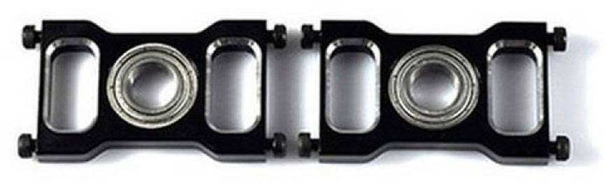 Two black metal components with recessed ball bearings lying side by side.