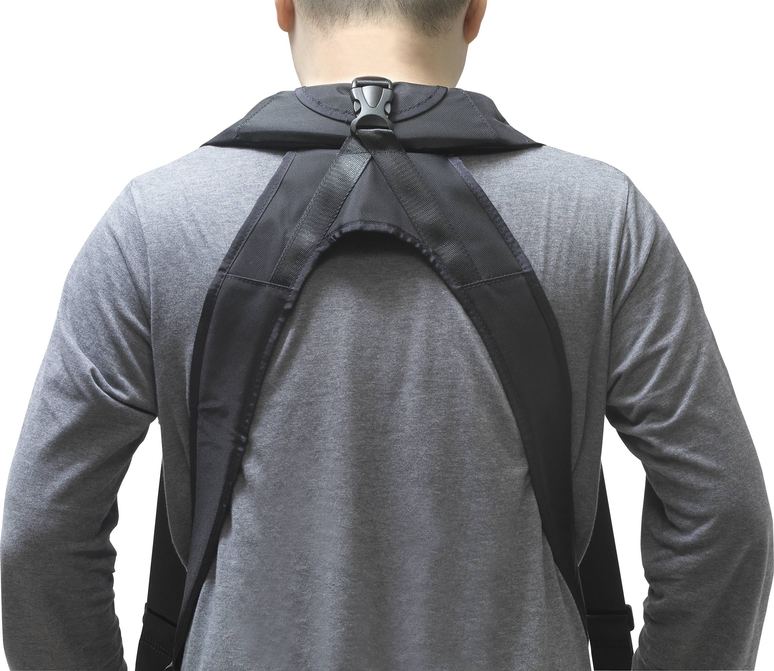 A person is wearing a black back support over a grey shirt, which offers adjustable straps for support and posture correction.