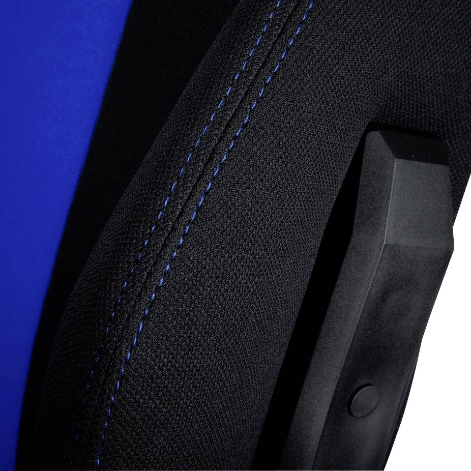Close-up of a black chair arm with a blue stitch. The background is partially blue.