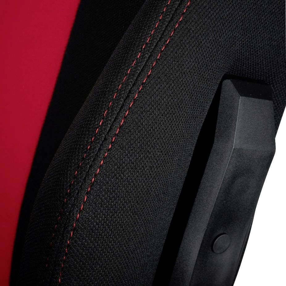 Close-up of a black fabric chair with a red stitch and black armrest piece.