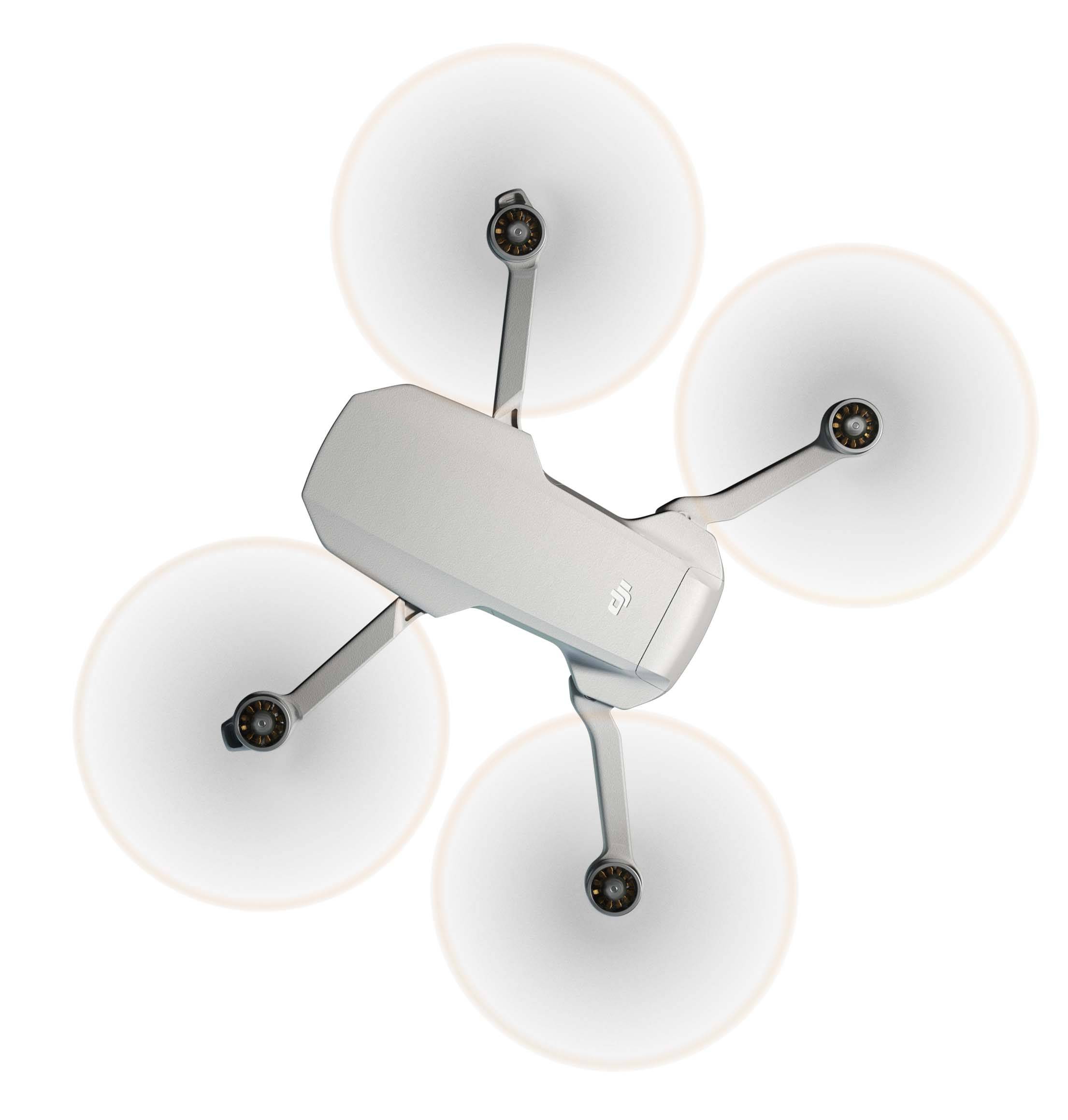 A white quadcopter drone hovers in the air, viewed from above.