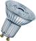 Transparent LED light bulb with GU10 fitting, ribbed surface, demonstrating modern energy-saving technology.