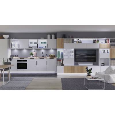 Modern kitchen and living room in an elegant design, with white and grey interior, wooden details, shelves and built-in TV.