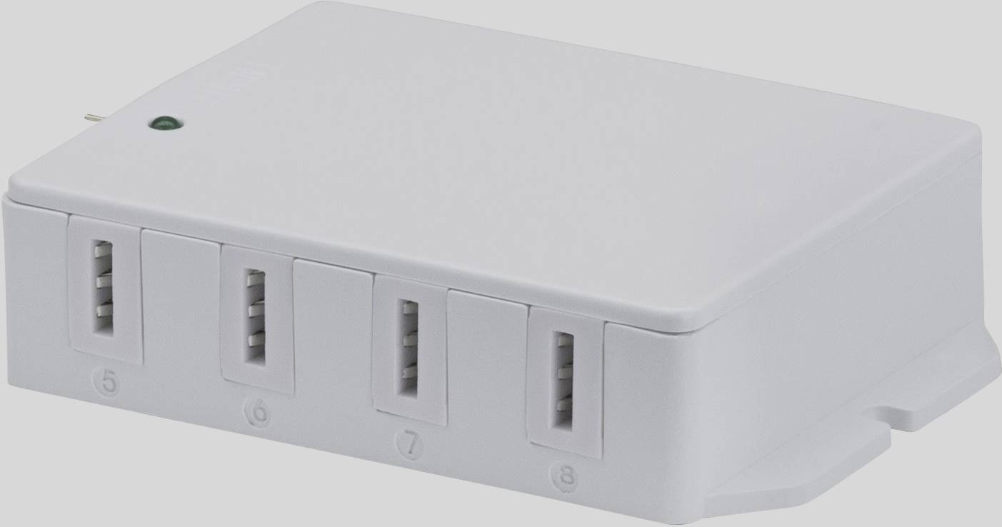 A white USB charging adapter with eight ports lies on a surface. A green indicator light shows it is ready for operation.