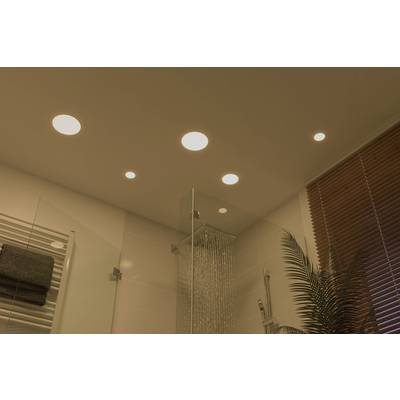Ceiling lighting in a modern bathroom with multiple recessed lights, a large shower enclosure, and plants on the window sill.