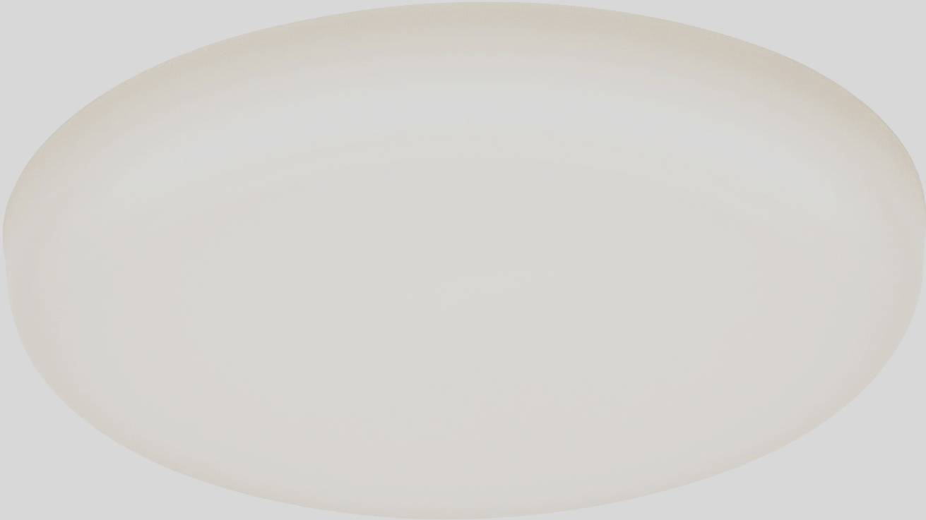 A round, flat ceiling light with uniform, soft illumination. Ideal for modern interiors and provides atmospheric lighting.