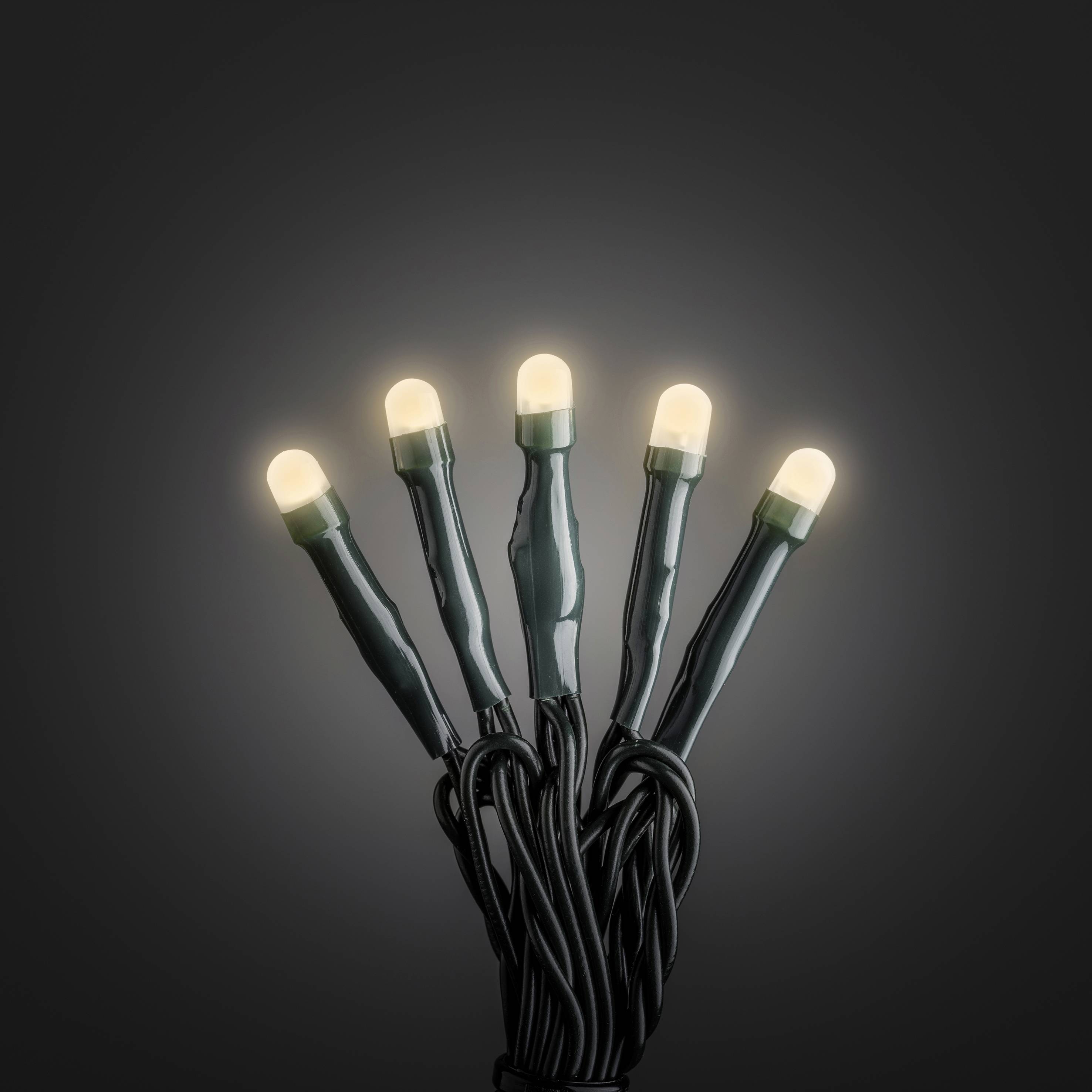Five glowing LED lights on a green cable against a dark background. The lights emit warm, bright light.