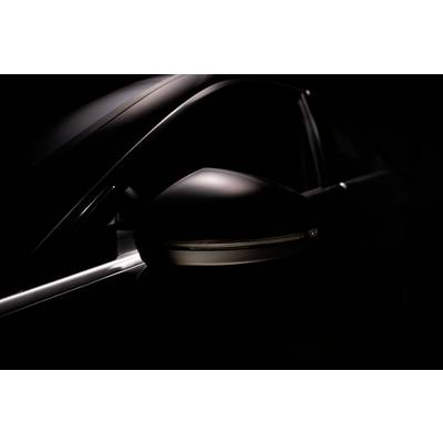A dark, minimalist image of a car's wing mirror, emphasising its smooth surface and elegant shape.