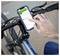 A person uses a smartphone mounted on a bicycle handlebar to navigate with a map app, indicating a biking route on the screen.