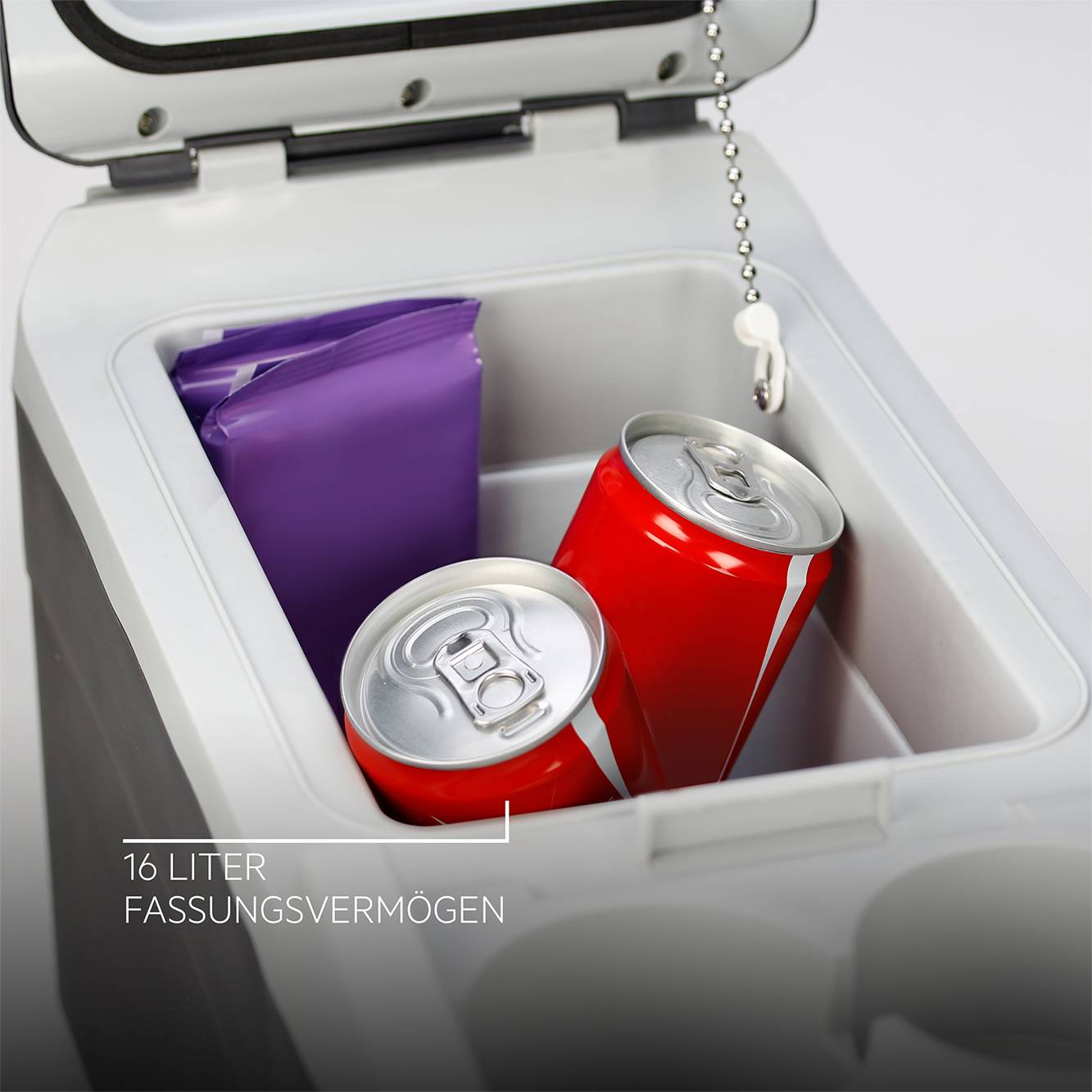 Cool box with open lid, two red drink cans and purple packaging inside. Label below: 16 litre capacity.