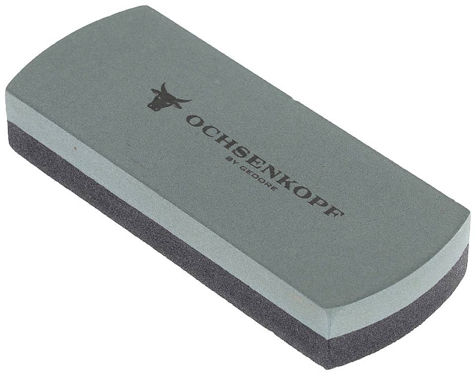 Grey grinding stone with the inscription 'Ochsenkopf by Gedore', top and bottom surfaces rounded.