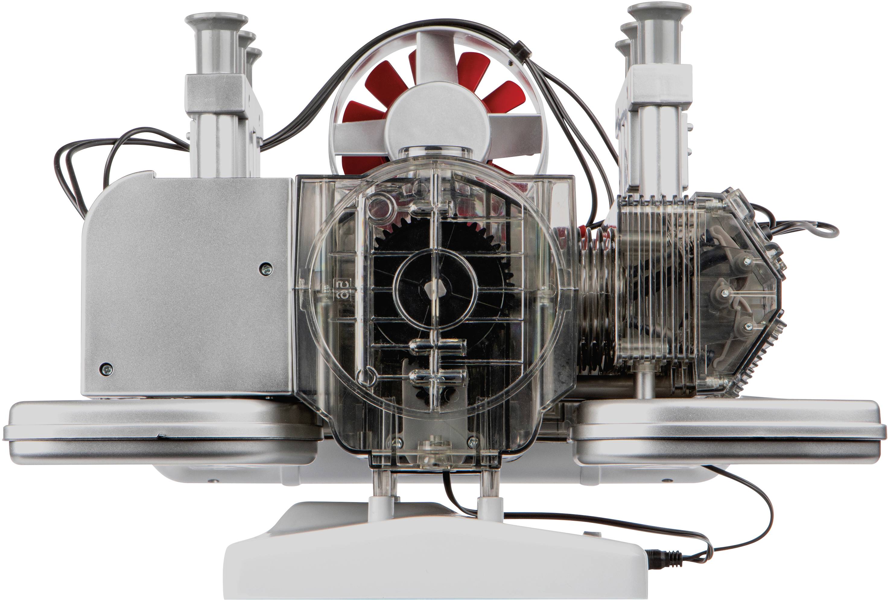 Machine with transparent components revealing the gears inside; a red fan surrounded by wires sits atop it.