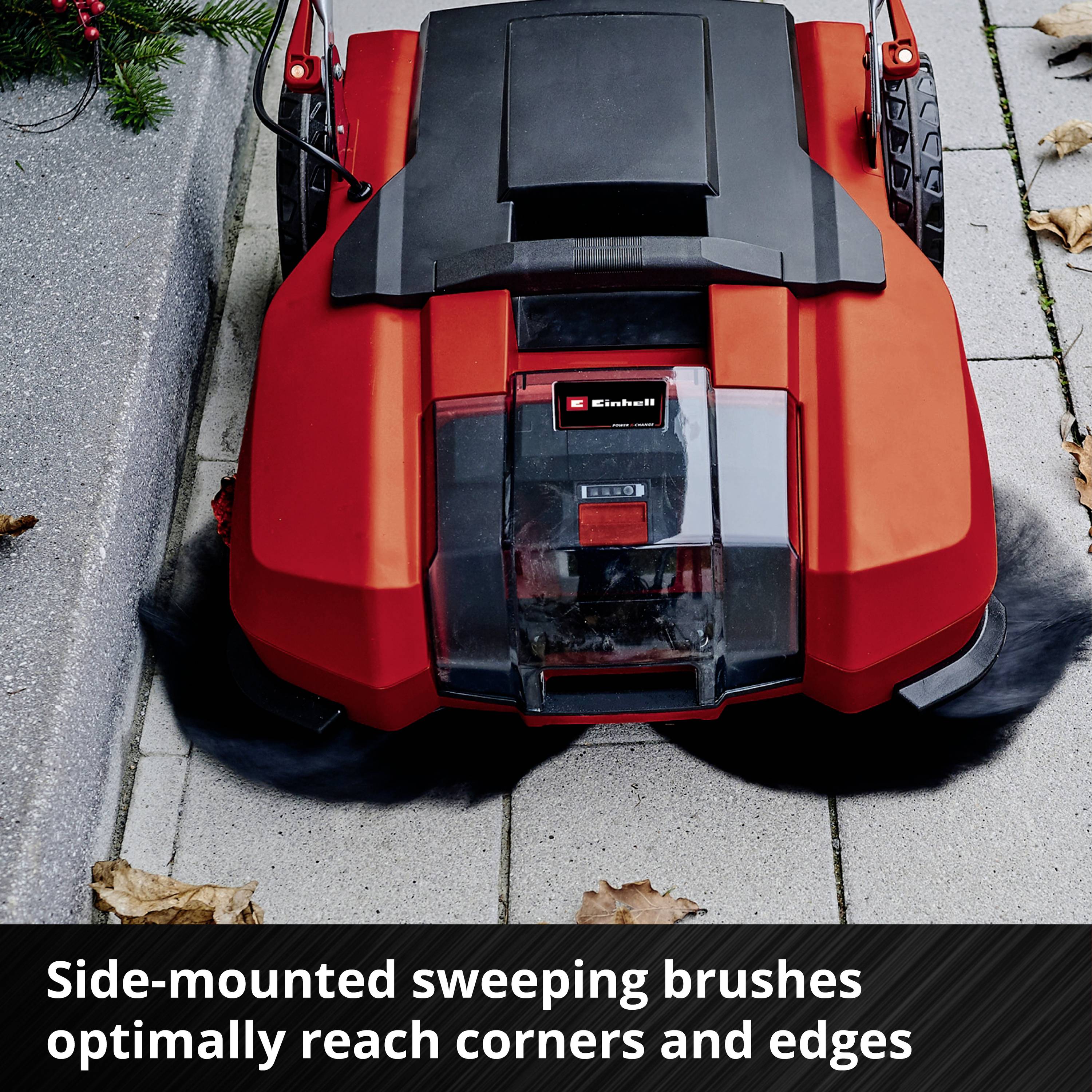 'A red robotic lawnmower on a pavement with a highlighted feature: side-positioned sweeping brushes for cleaning corners.'