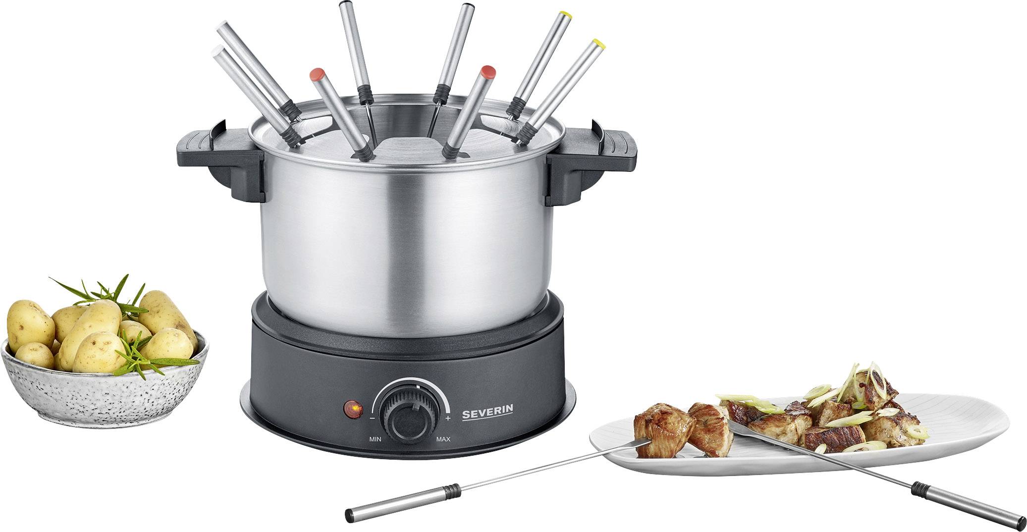 An electric fondue set with multiple forks in a pot; beside it lies a plate of meat and a small bowl of potatoes.