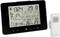 Black weather station with digital display: Time '1:24 PM', weather forecast, temperature 29°C indoors, 26°C outdoors, humidity 54%.