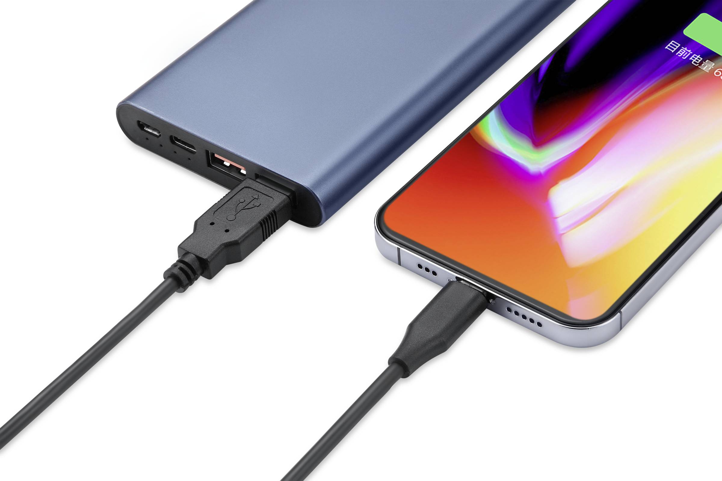 A smartphone is being charged via a cable connected to a power bank. The power bank is blue, and the smartphone displays a colourful screen.