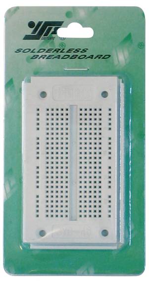 A white solderless breadboard in a green packaging with the inscription 'Solderless Breadboard' on top.