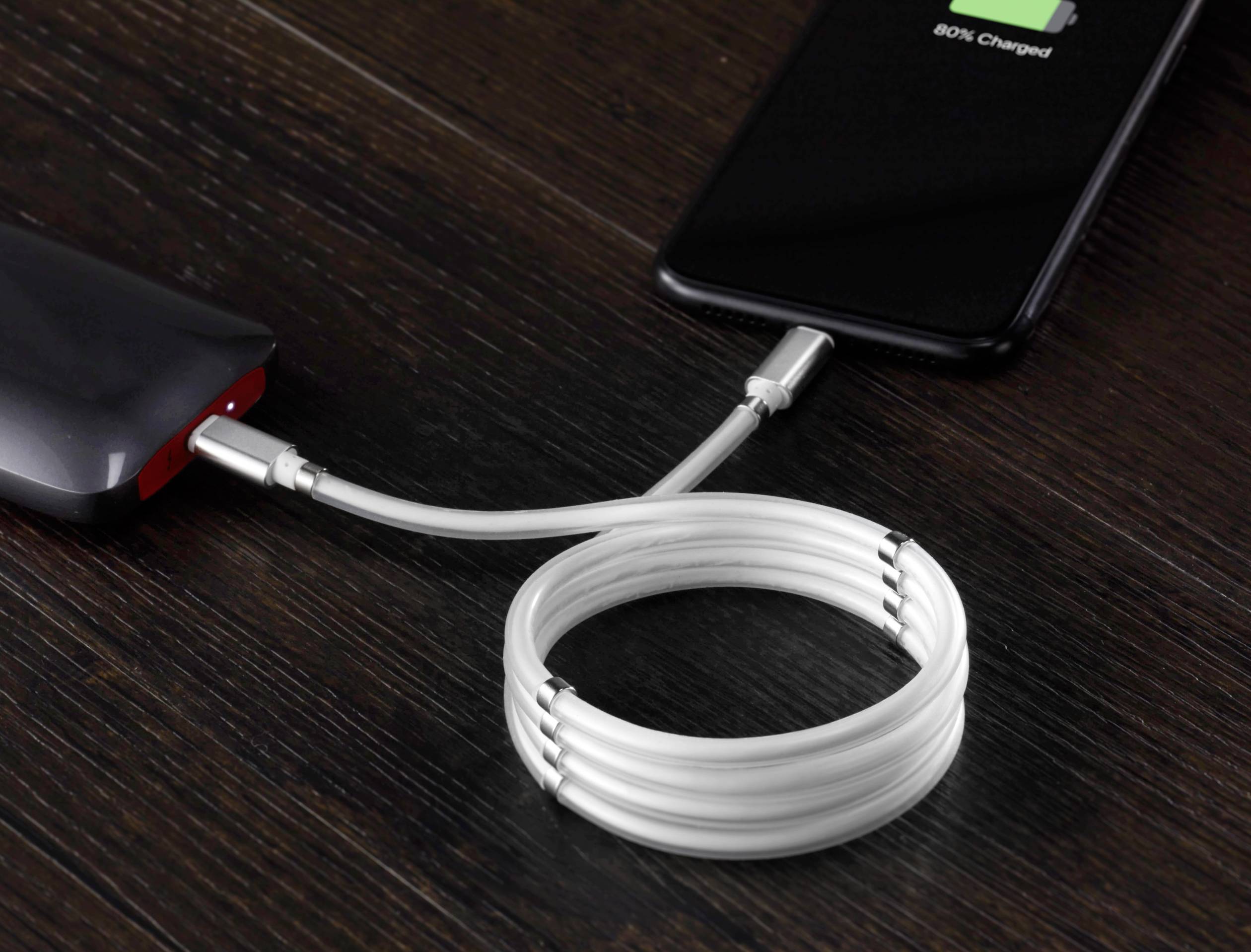 A smartphone is being charged from a power bank with a white cable. The display shows a battery level of 80%.
