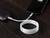 A smartphone is being charged from a power bank with a white cable. The display shows a battery level of 80%.