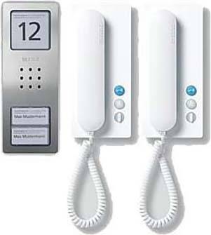 Intruder alarm systems with a silver bell system and two white intercom units, each with a handset and buttons.