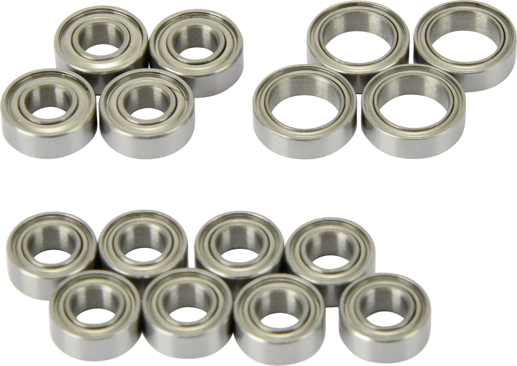 Several small metal ball bearings arranged in two groups on a white background. They appear to be manufactured from stainless steel.
