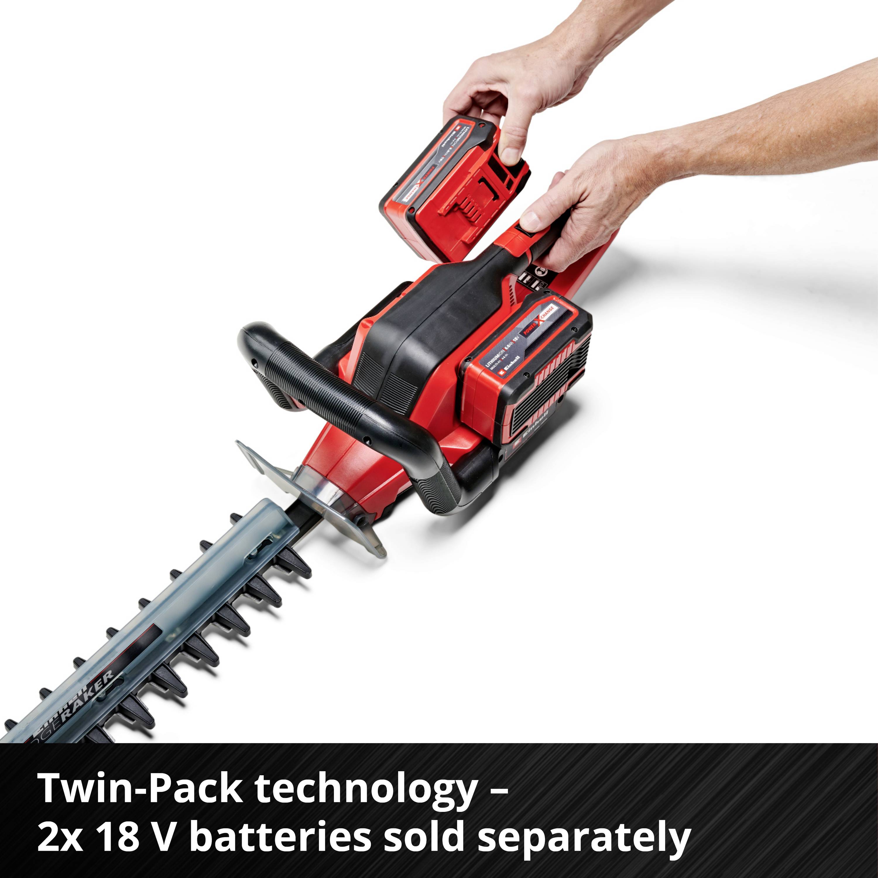 A person is replacing the battery of a red hedge trimmer. Text in the image: 'Twin-Pack Technology - 2 x 18 V. Batteries sold separately'.