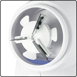 A white kitchen appliance with rotating blades, most likely a blender or food processor, shows the blades in close-up.