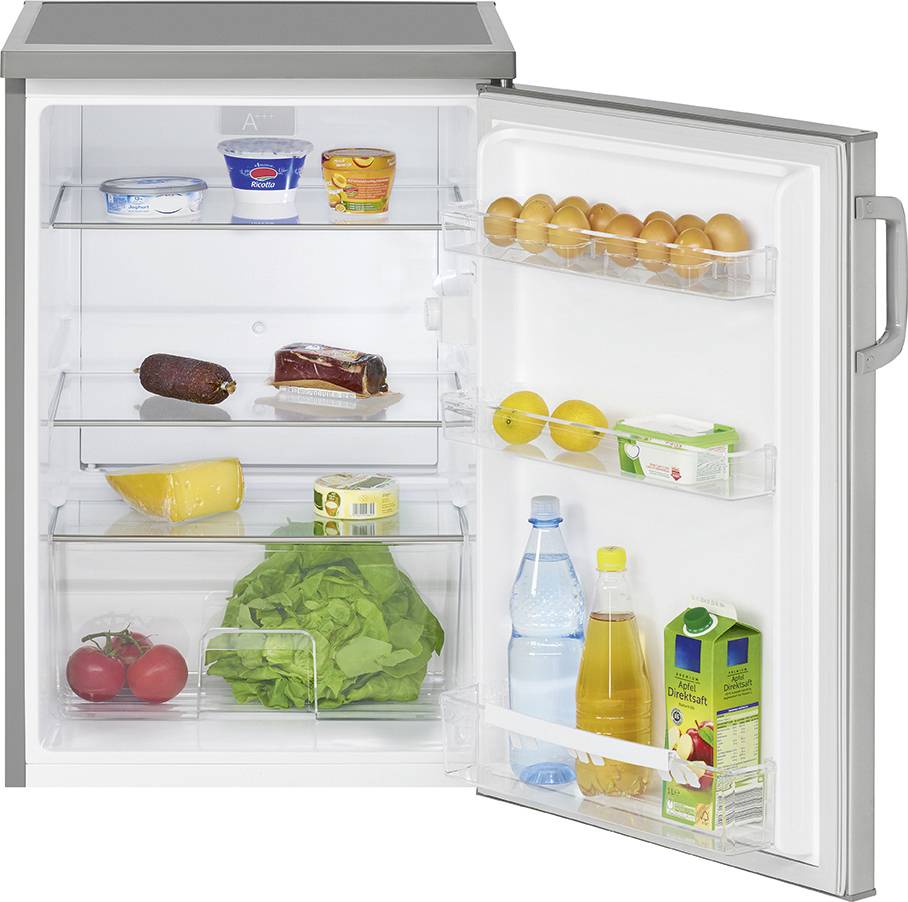 An open fridge reveals various foods, including eggs, lemons, a water bottle, a juice carton, vegetables, and yoghurt.