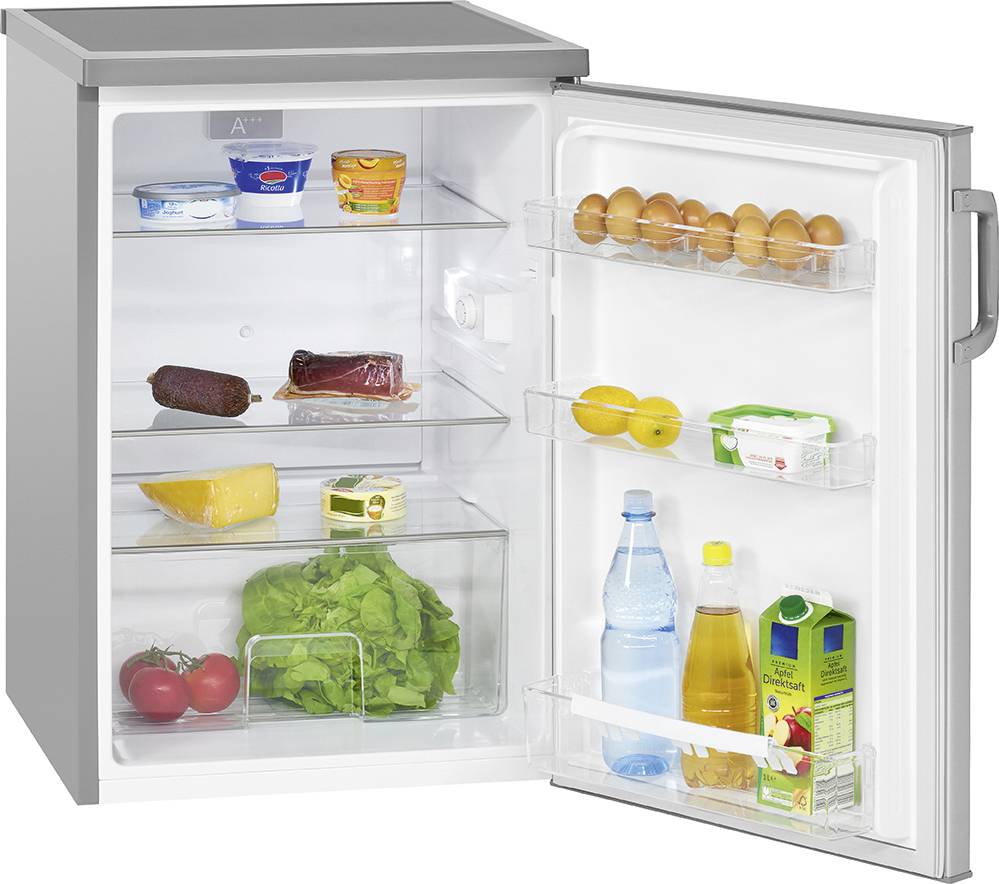 An open fridge, stocked with fruit, vegetables, drinks, eggs, and dairy products.
