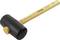 A black rubber mallet with a wooden handle lies diagonally. The handle points upwards to the right.