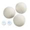 Three white dryer balls made from 100% New Zealand wool; label text: 'Saves time and energy'.