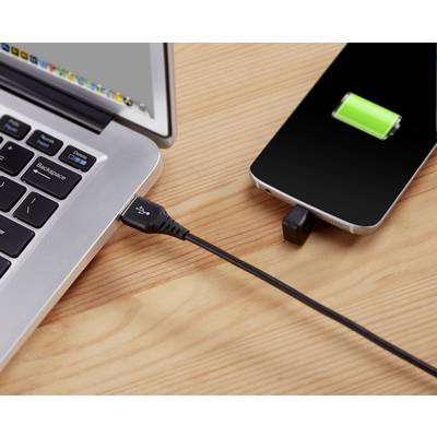 A smartphone is being charged via a USB cable on a laptop, with a green battery symbol indicating the charging status.