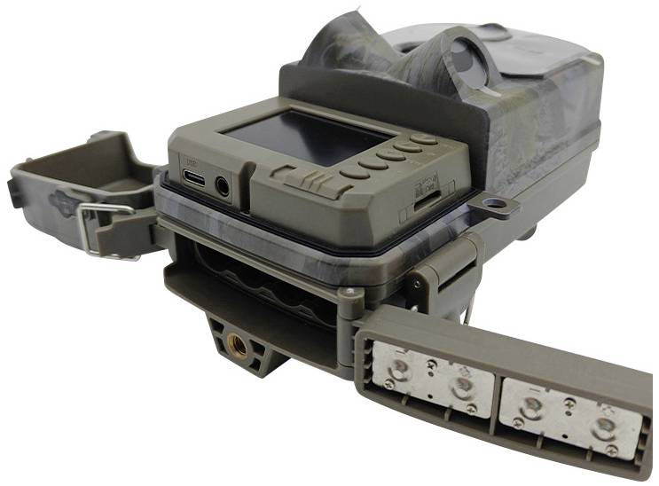 A camouflage trail camera with open covers and various connections, suitable for wildlife monitoring.