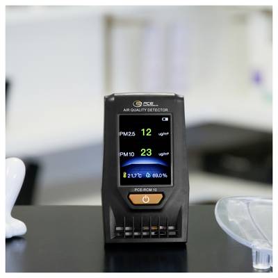 Portable air quality detector on a desk showing PM2.5 12 ug/m³, PM10 23 ug/m³, 21.7°C, and 69.0% humidity.<br>