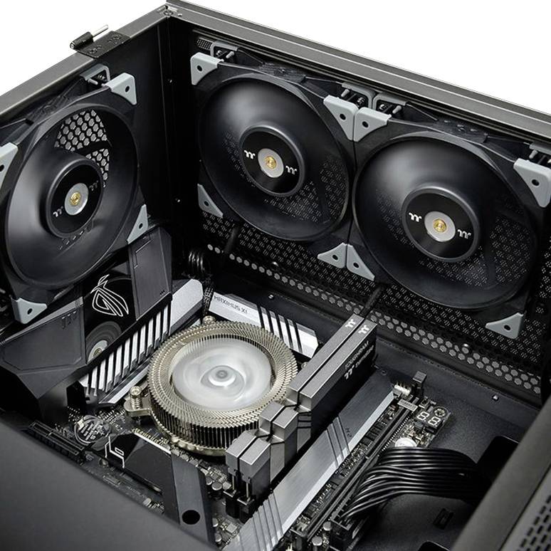 Open computer with a CPU cooler, three large fans at the top, and visible motherboard components.