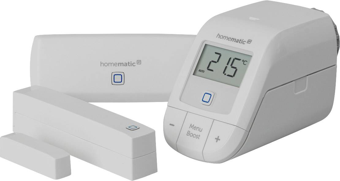 An electronic radiator thermostat with display shows 21.5°C. Beside it lie two sensor devices, all from the brand 'homematic'.