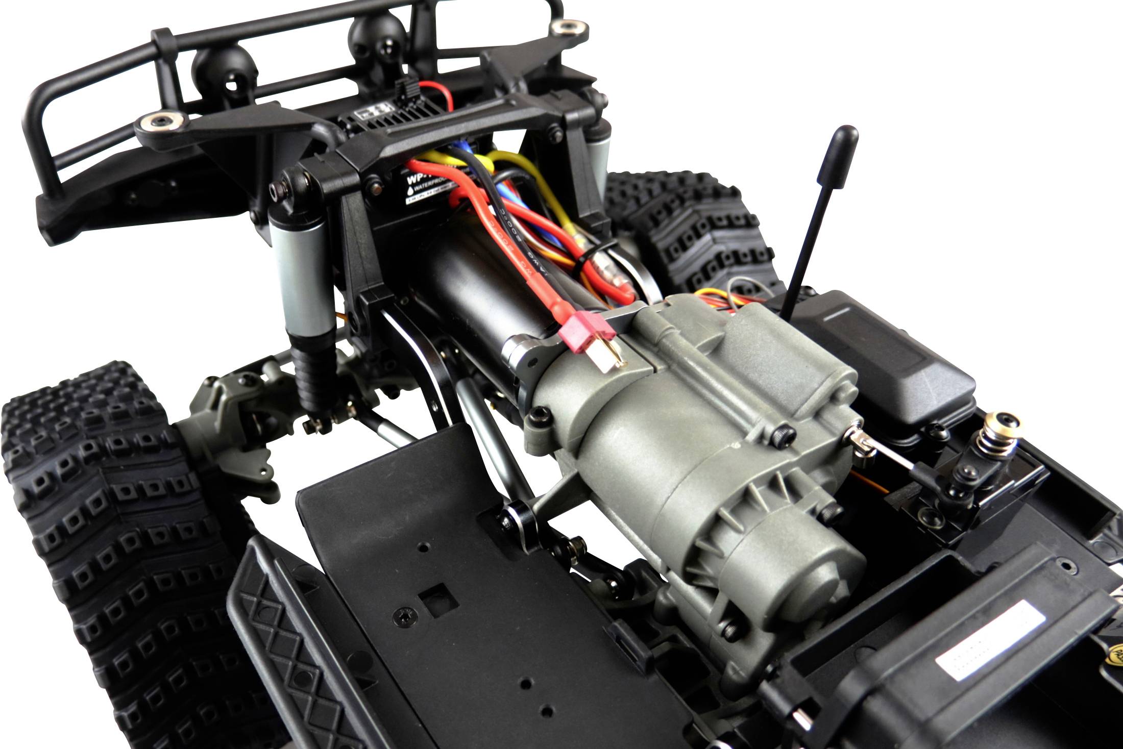 Close-up of a remote-controlled off-road vehicle without bodywork, showing the engine and wiring.