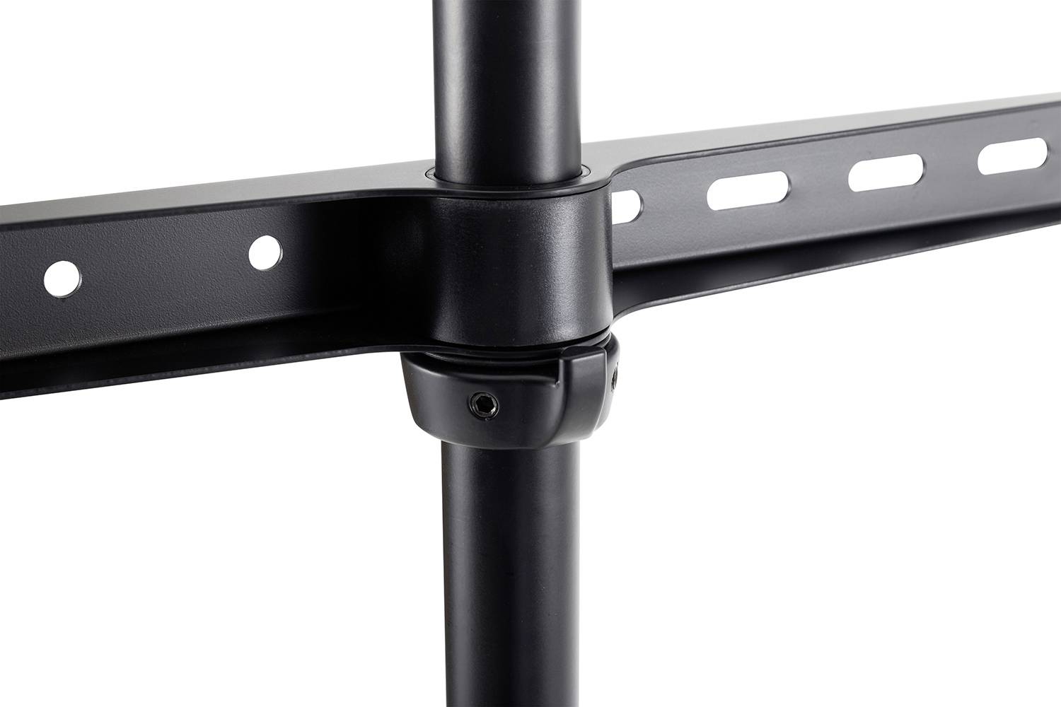 Close-up of a black metal bracket connecting two pipes, with multiple fixing holes on a crossbar.