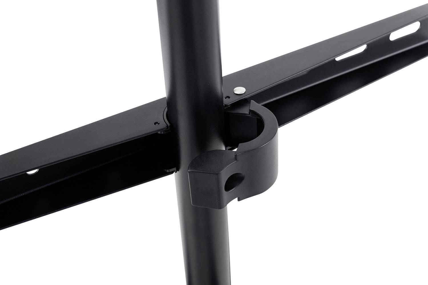 Close-up of a black, cross-shaped metal bracket with screw holes, connecting parts of a framework together.